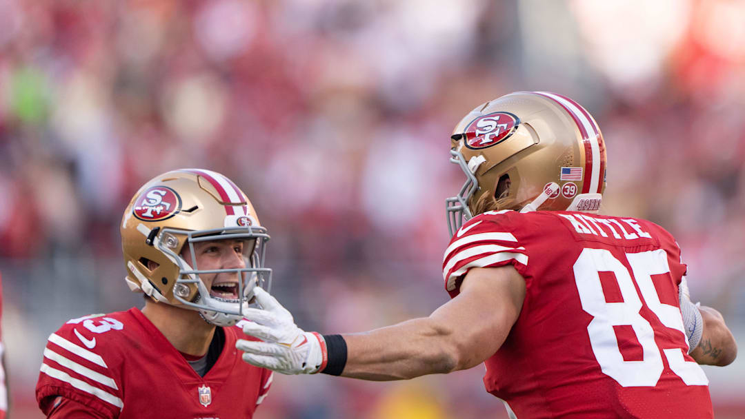 Brock Purdy (13) and tight end George Kittle (85) celebrate against the Washington Commanders. Mandatory Credit: Stan Szeto-Imagn Images