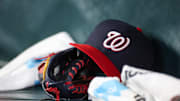 May 30, 2024; Atlanta, Georgia, USA; A detailed view of a Washington Nationals hat and glove on the bench against the Atlanta Braves in the ninth inning at Truist Park. 