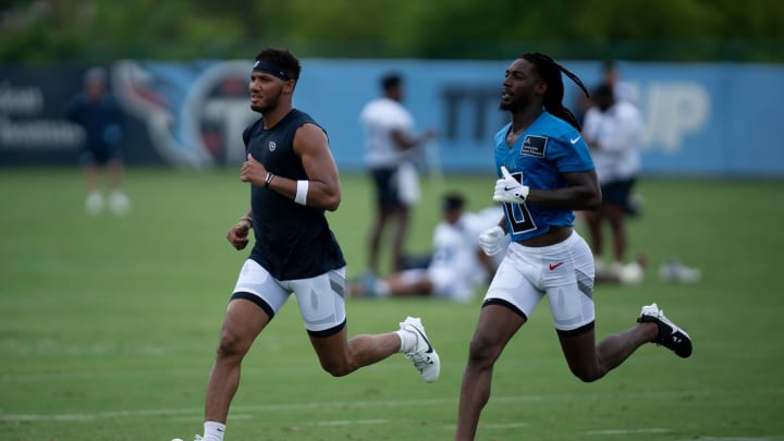 Tennessee Titans wide receivers Tyler Boyd (left) and Calvin Ridley warm down on the second day of training camp Thursday, July 25, 2024.