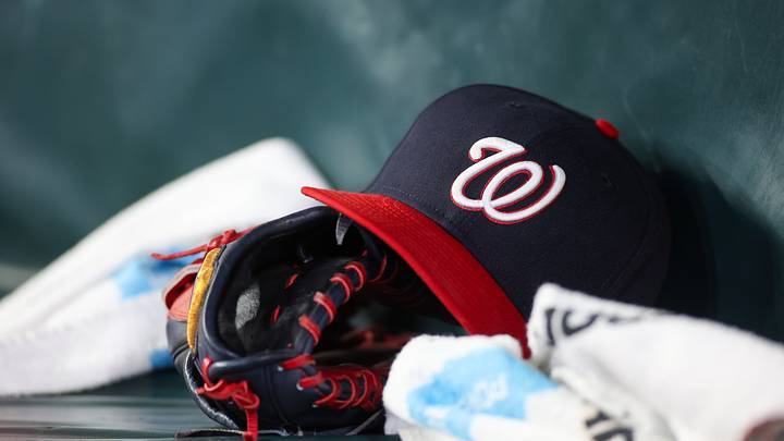 May 30, 2024; Atlanta, Georgia, USA; A detailed view of a Washington Nationals hat and glove on the bench against the Atlanta Braves in the ninth inning at Truist Park. Mandatory Credit: Brett Davis-USA TODAY Sports