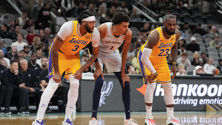 Anthony Davis, Victor Wembanyama and LeBron James line up for a free throw attempt.