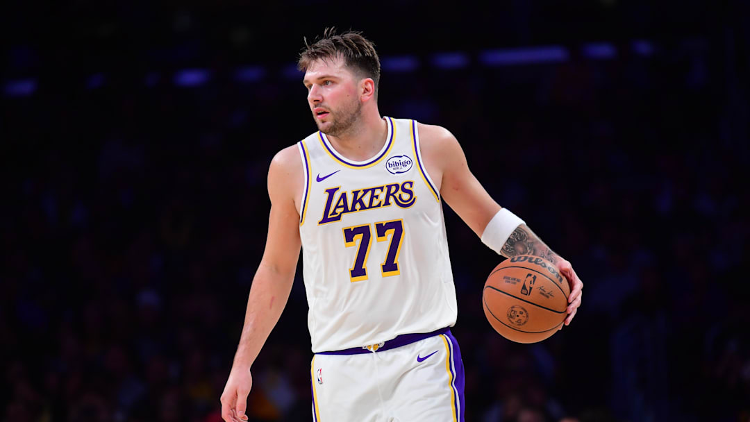 Nov 30, 2025; Los Angeles, California, USA; Los Angeles Lakers guard Luka Doncic (77) controls the ball against the New Orleans Pelicans during the first half at Crypto.com Arena. Mandatory Credit: Gary A. Vasquez-Imagn Images