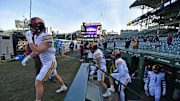 Nov 22, 2025; Chicago, Illinois, USA; The Minnesota Golden Gophers enter the field from the dugout prior to a game against the Northwestern Wildcats at Wrigley Field. Mandatory Credit: Patrick Gorski-Imagn Images