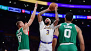 Dec 25, 2023; Los Angeles, California, USA; Los Angeles Lakers forward Anthony Davis (3) shoots against Boston Celtics center Kristaps Porzingis (8) during the first half at Crypto.com Arena. Mandatory Credit: Gary A. Vasquez-Imagn Images