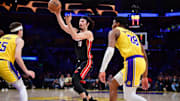 January 15, 2025; Los Angeles, California, USA; Miami Heat guard Jaime Jaquez Jr. (11) passes the ball against Los Angeles Lakers guard Austin Reaves (15) and forward Rui Hachimura (28) during the first half at Crypto.com Arena. Mandatory Credit: Gary A. Vasquez-Imagn Images