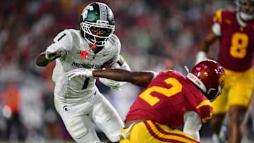 Sep 20, 2025; Los Angeles, California, USA; Michigan State Spartans wide receiver Omari Kelly (1) runs the ball against Southern California Trojans cornerback DJ Harvey (2) during the first half at the Los Angeles Memorial Coliseum. Mandatory Credit: Gary A. Vasquez-Imagn Images