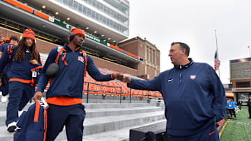 Nov 16, 2024; Champaign, Illinois, USA; Illinois Fighting Illini head coach Bret Bielema gives a hand to players before the game against the Michigan State Spartans at Memorial Stadium. Mandatory Credit: Ron Johnson-Imagn Images