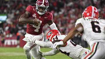 Sep 28, 2024; Tuscaloosa, Alabama, USA;  Georgia Bulldogs defensive back Malaki Starks (24) tackles Alabama Crimson Tide quarterback Jalen Milroe (4) at Bryant-Denny Stadium. Alabama defeated Georgia 41-34. Mandatory Credit: Gary Cosby Jr.-Imagn Images