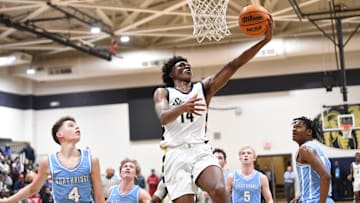 Feb 8, 2024; Tuscaloosa, Alabama, USA; Paul Bryant guard Adrian Wooley (14) goes to the basket over several Northridge defenders in the 6A Area Final at Paul W. Bryant High School. Bryant defeated Northridge 70-59 to claim the area title.