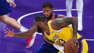 dec 22, 2020; los angeles, california, usa;  los angeles lakers forward lebron james (23) controls the ball against la clippers guard paul george (13) in the second half  at staples center. the clippers defeated the lakers. mandatory credit: kirby lee-usa today sports