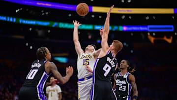 Dec 28, 2024; Los Angeles, California, USA; Los Angeles Lakers guard Austin Reaves (15) plays for the rebound against Sacramento Kings forward DeMar DeRozan (10) and guard Kevin Huerter (9) during the second half at Crypto.com Arena. Mandatory Credit: Gary A. Vasquez-Imagn Images