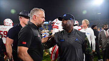 Nov 8, 2025; Pasadena, California, USA; Nebraska Cornhuskers head coach Matt Rhule meets with UCLA Bruins interim head coach Tim Skipper following the game at the Rose Bowl. Mandatory Credit: Gary A. Vasquez-Imagn Images