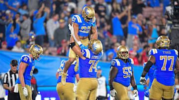 Nov 8, 2025; Pasadena, California, USA; UCLA Bruins running back Anthony Frias II (22) celebrates his touchdown scored against the Nebraska Cornhuskers with offensive lineman Julian Armella (74) during the second half at the Rose Bowl. Mandatory Credit: Gary A. Vasquez-Imagn Images