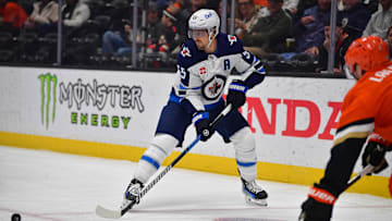 Dec 18, 2024; Anaheim, California, USA; Winnipeg Jets center Mark Scheifele (55) controls the puck against the Anaheim Ducks during the first period at Honda Center. Mandatory Credit: Gary A. Vasquez-Imagn Images