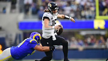 Dec 5, 2021; Inglewood, California, USA; Jacksonville Jaguars quarterback Trevor Lawrence (16) moves the ball against Los Angeles Rams defensive end Greg Gaines (91) during the first half at SoFi Stadium. Mandatory Credit: Gary A. Vasquez-Imagn Images