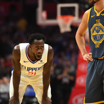 Nov 12, 2018; Los Angeles, CA, USA; Los Angeles Clippers guard Patrick Beverley (21) yells at the Golden State Warriors bench in the closing seconds of the Clippers 121-116 win. Right is Golden State Warriors guard Klay Thompson (11). at Staples Center. Mandatory Credit: Robert Hanashiro-USA TODAY Sports