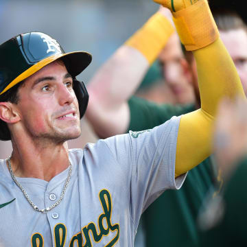 Oakland Athletics third baseman Armando Alvarez (50) is greeted after scoring a run against the Los Angeles Angels during the third inning at Angel Stadium on June 25.