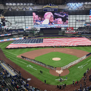 Apr 2, 2024; Milwaukee, Wisconsin, USA; Players and fans stand for the National Anthem before game between the Milwaukee Brewers and Minnesota Twins at American Family Field.