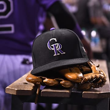 Aug 4, 2017; Denver, CO, USA; General view of the hat and glove of Colorado Rockies shortstop Pat Valaika (4) (not pictured) in the seventh inning against the Philadelphia Phillies at Coors Field. Mandatory Credit: Ron Chenoy-Imagn Images