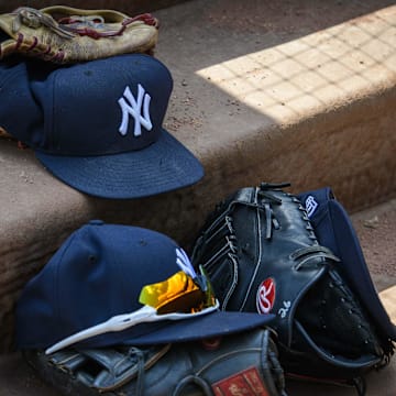 Sep 29, 2019; Arlington, TX, USA; A view of a New York Yankees cap and glove and logo during the game between the Rangers and the Yankees in the final home game at Globe Life Park in Arlington. Mandatory Credit: Jerome Miron-Imagn Images