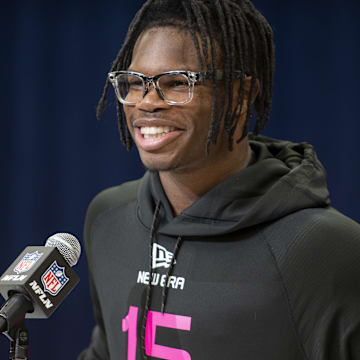 Hunter flashes a smile at the NFL combine podium in Indianapolis.