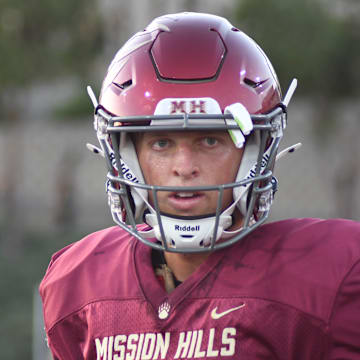 Mission Hills junior quarterback Troy Huhn warms up prior to the 2024 season opener