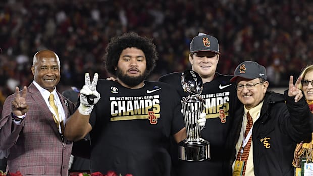 122/125SC Trojans defensive tackle Stevie Tu'ikolovatu (96) and quarterback Sam Darnold (14) celebrate after winning the Ros