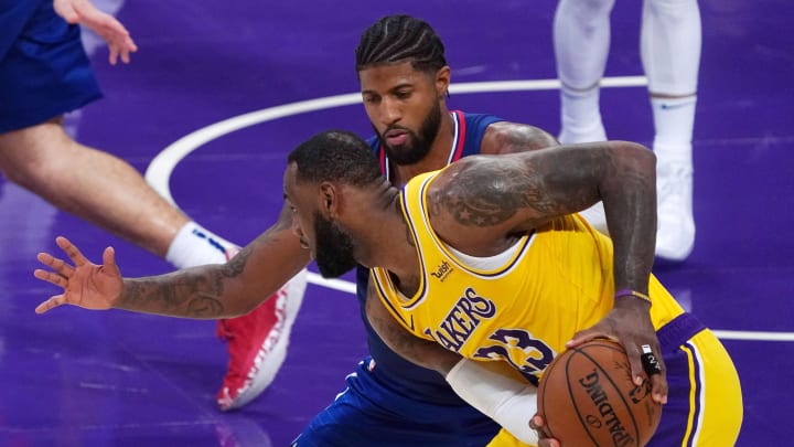 dec 22, 2020; los angeles, california, usa;  los angeles lakers forward lebron james (23) controls the ball against la clippers guard paul george (13) in the second half  at staples center. the clippers defeated the lakers. mandatory credit: kirby lee-usa today sports