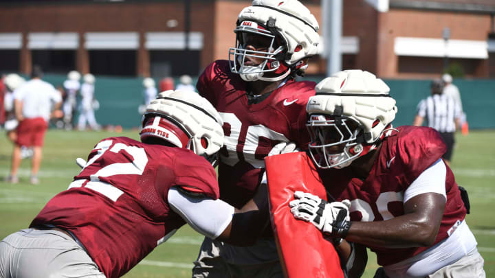 The Alabama Crimson Tide football team works out Sunday morning in practice as they prepare for the 2024 season. Alabama defensive lineman LT Overton (22) goes against Alabama defensive lineman Jordan Renaud (90) and Alabama defensive lineman Jah-Marien Latham (20).