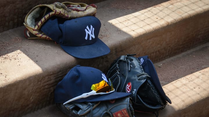 Sep 29, 2019; Arlington, TX, USA; A view of a New York Yankees cap and glove and logo during the game between the Rangers and the Yankees in the final home game at Globe Life Park in Arlington. Mandatory Credit: Jerome Miron-USA TODAY Sports