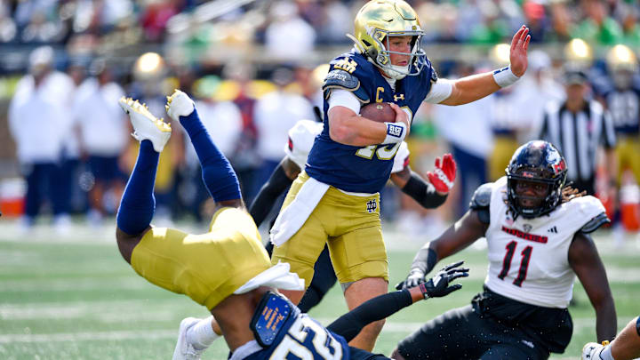 Sep 7, 2024; South Bend, Indiana, USA; Notre Dame Fighting Irish quarterback Riley Leonard (13) runs for a touchdown in the first quarter against the Northern Illinois Huskies at Notre Dame Stadium. Mandatory Credit: Matt Cashore-Imagn Images