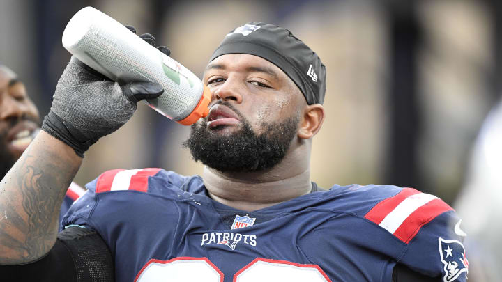 Nov 6, 2022; Foxborough, Massachusetts, USA;  New England Patriots defensive tackle Davon Godchaux (92) takes a drink during the second half against the Indianapolis Colts at Gillette Stadium. Mandatory Credit: Bob DeChiara-USA TODAY Sports