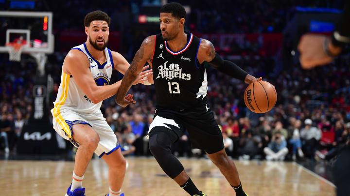 Mar 15, 2023; Los Angeles, California, USA; Los Angeles Clippers forward Paul George (13) moves the ball against Golden State Warriors guard Klay Thompson (11) during the second half at Crypto.com Arena. 