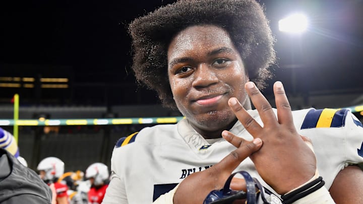 Bellevue lineman Demetri Manning shows where his championship ring belongs after Bellevue defeated Yelm for WIAA Class 3A football title in 2023.