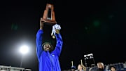Miami Northwestern's Teddy Bridgewater raises the state trophy following the team's win over Raines in the Class 3A championship on Dec. 14, 2024.