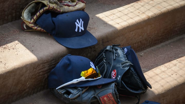 Sep 29, 2019; Arlington, TX, USA; A view of a New York Yankees cap and glove and logo during the game between the Rangers and the Yankees in the final home game at Globe Life Park in Arlington. Mandatory Credit: Jerome Miron-USA TODAY Sports