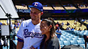 Jul 18, 2022; Los Angeles, CA, USA; Texas Rangers shortstop Corey Seager (5) poses for a photograph with wife Madisyn during batting practice at Dodger Stadium.