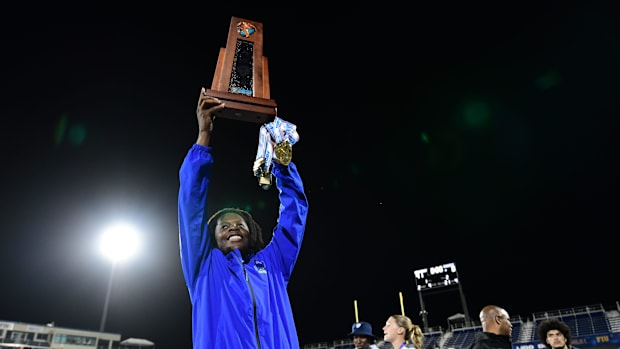 Miami Northwestern's Teddy Bridgewater raises the state trophy following the team's win over Raines in the Class 3A champions