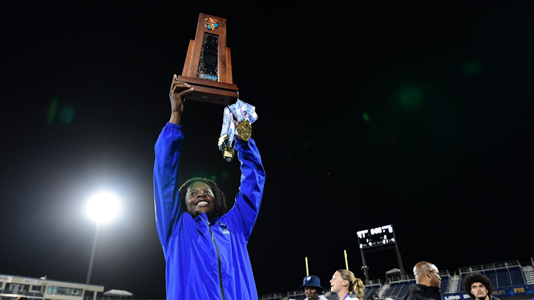 Miami Northwestern's Teddy Bridgewater raises the state trophy following the team's win over Raines in the Class 3A championship on Dec. 14, 2024.