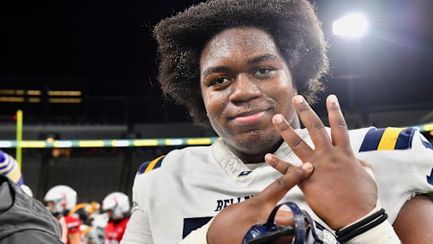 Bellevue lineman Demetri Manning shows where his championship ring belongs after Bellevue defeated Yelm for Class 3A title. 