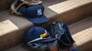 Sep 29, 2019; Arlington, TX, USA; A view of a New York Yankees cap and glove and logo during the game between the Rangers and the Yankees in the final home game at Globe Life Park in Arlington. Mandatory Credit: Jerome Miron-USA TODAY Sports