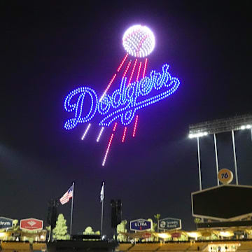 Mar 28, 2025; Los Angeles, California, USA; A Los Angeles Dodgers logo is projected during a drone show at Dodger Stadium. Mandatory Credit: Kirby Lee-Imagn Images
