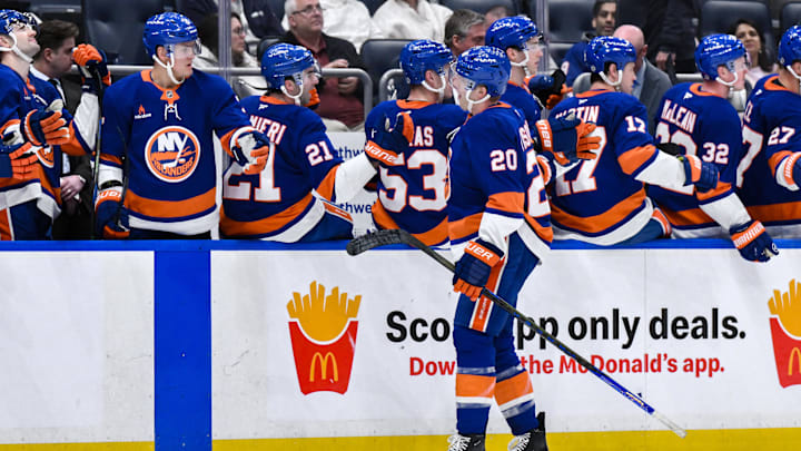 Apr 15, 2025; Elmont, New York, USA; New York Islanders right wing Hudson Fasching (20) celebrates with teammates after scoring a goal against the Washington Capitals during the third period at UBS Arena. Mandatory Credit: John Jones-Imagn Images