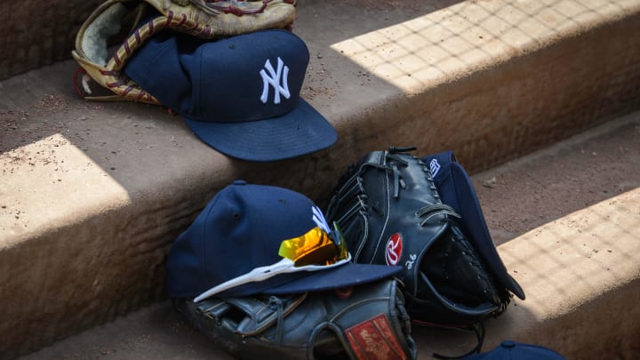 Sep 29, 2019; Arlington, TX, USA; A view of a New York Yankees cap and glove and logo during the game between the Rangers and the Yankees in the final home game at Globe Life Park in Arlington. Mandatory Credit: Jerome Miron-USA TODAY Sports