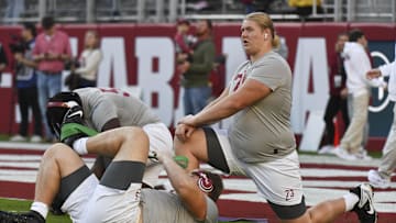 Nov 4, 2023; Tuscaloosa, Alabama, USA; Alabama Crimson Tide offensive lineman Olaus Alinen (73) stretches on the field at Bryant-Denny Stadium before a game against the LSU Tigers. Mandatory Credit: Gary Cosby Jr.-USA TODAY Sports