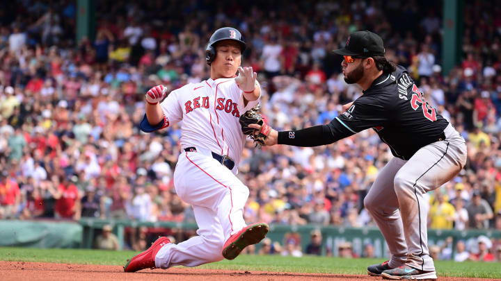 Aug 25, 2024; Boston, Massachusetts, USA; Boston Red Sox designated hitter Masataka Yoshida (7) is tagged out by Arizona Diamondbacks third baseman Eugenio Suarez (28) during the fourth inning at Fenway Park. Mandatory Credit: Eric Canha-USA TODAY Sports