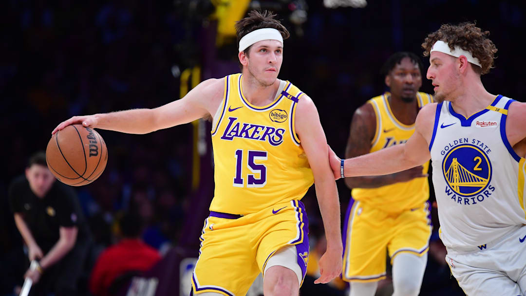 Apr 3, 2025; Los Angeles, California, USA; Los Angeles Lakers guard Austin Reaves (15) moves the ball against Golden State Warriors guard Brandin Podziemski (2) during the first half at Crypto.com Arena. Mandatory Credit: Gary A. Vasquez-Imagn Images