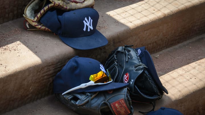 Sep 29, 2019; Arlington, TX, USA; A view of a New York Yankees cap and glove and logo during the game between the Rangers and the Yankees in the final home game at Globe Life Park in Arlington. Mandatory Credit: Jerome Miron-USA TODAY Sports