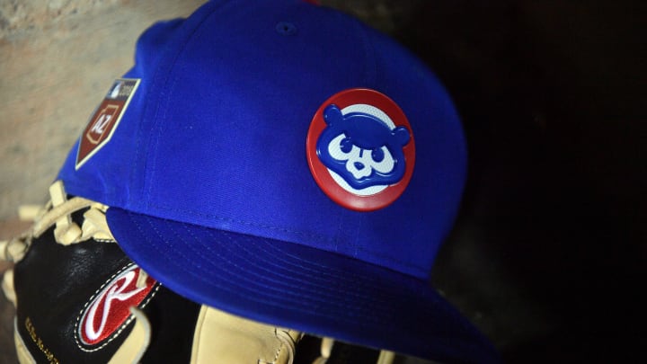 Mar 24, 2018; Peoria, AZ, USA; A Chicago Cubs cap sits on the dugout steps during the second inning of the game against the Seattle Mariners at Peoria Sports Complex. 