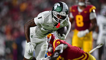Sep 20, 2025; Los Angeles, California, USA; Michigan State Spartans wide receiver Omari Kelly (1) runs the ball against Southern California Trojans cornerback DJ Harvey (2) during the first half at the Los Angeles Memorial Coliseum. Mandatory Credit: Gary A. Vasquez-Imagn Images